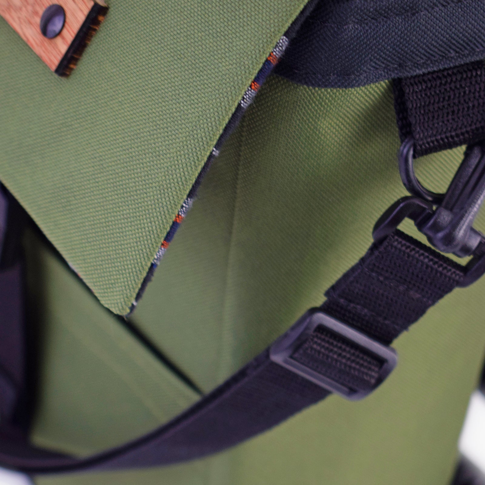 Mini Merchant Backpack in Olive Green, showcasing its multifunctional design and stylish appearance.