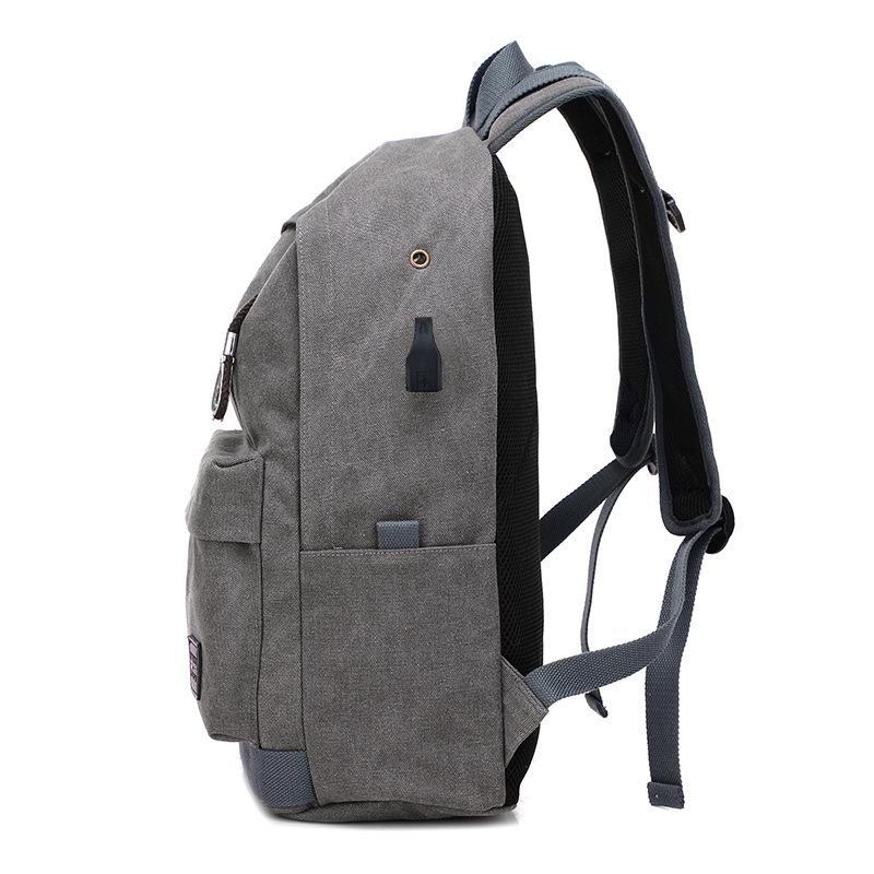 Multi-function unisex canvas backpack featuring a USB charging port, spacious compartments, and a stylish design.