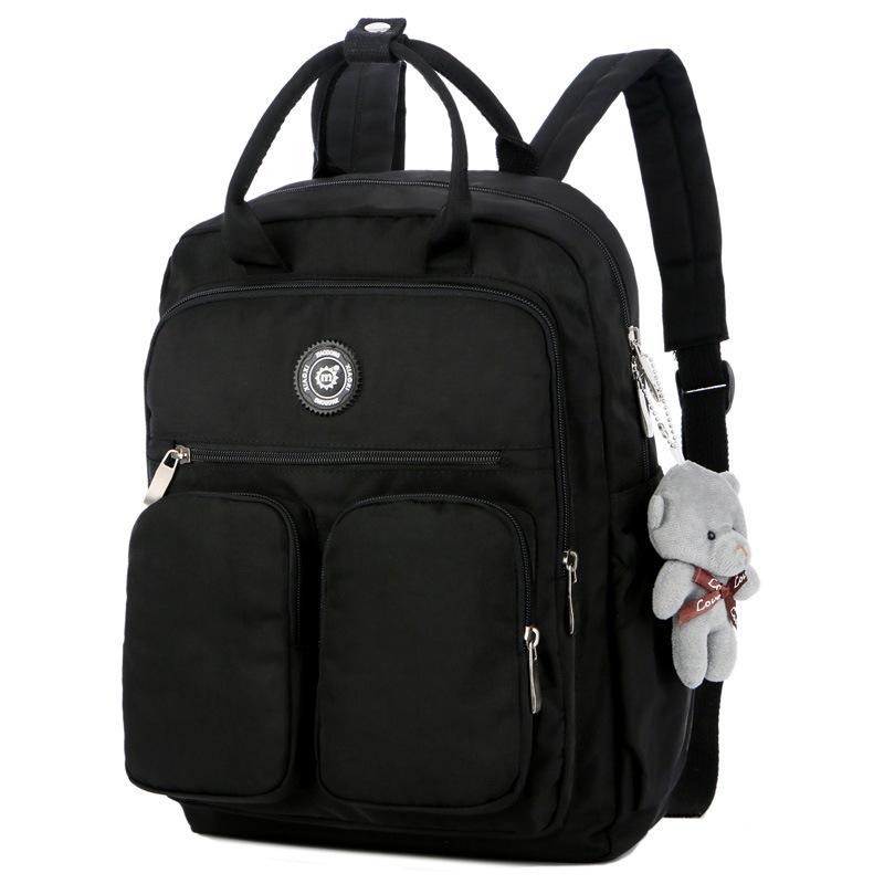 Nylon large capacity multi-function backpack featuring a cute toy bear, showcasing its spacious design and soft straps.