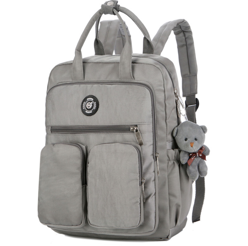 Nylon large capacity multi-function backpack featuring a cute toy bear, showcasing its spacious design and soft straps.