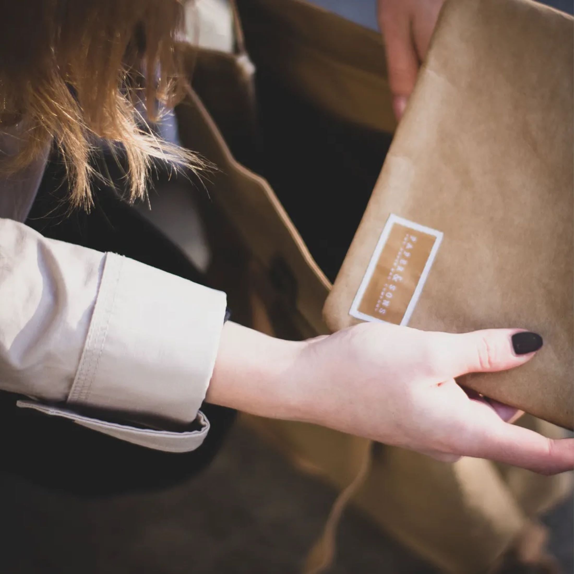 Oak Mini Bundle featuring a durable Kraft paper backpack and travel pouch, showcasing their water-resistant design and practical compartments.