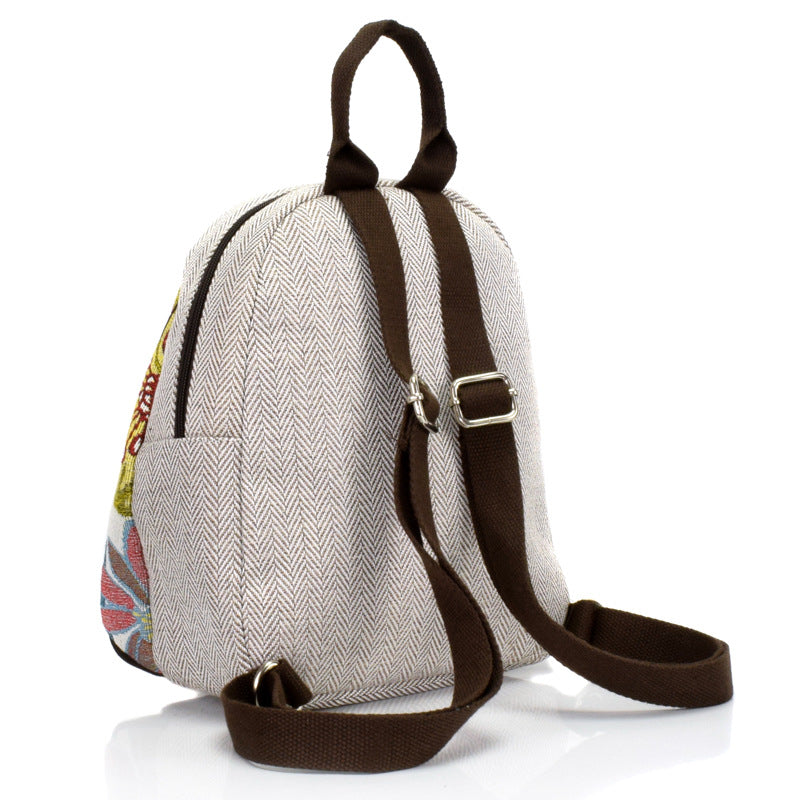 A stylish retro woven backpack for women made of cotton and linen, featuring a shell shape and multiple pockets.