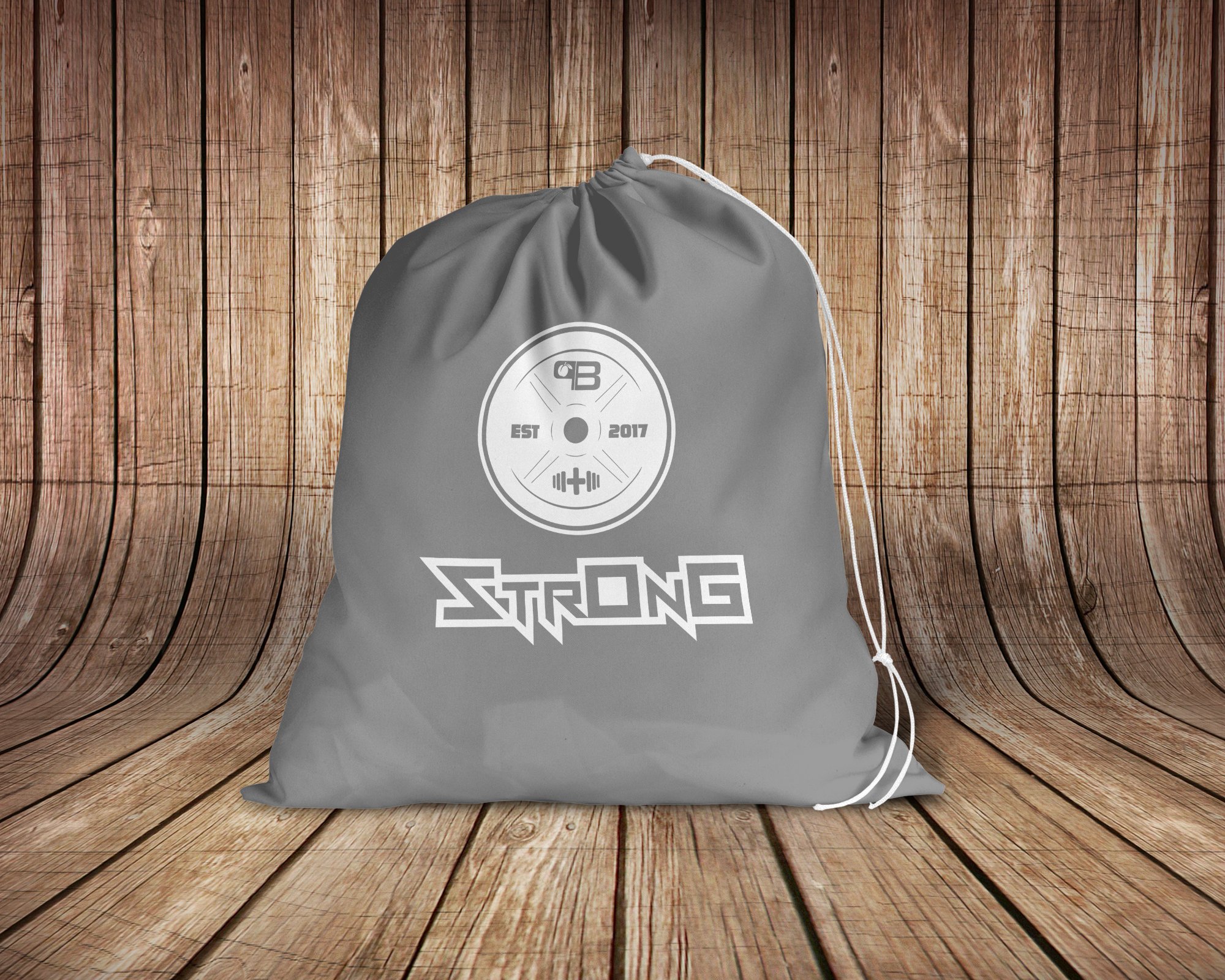 A stylish white StrOnG drawstring bag featuring black text, perfect for carrying gym clothes, school supplies, and more.