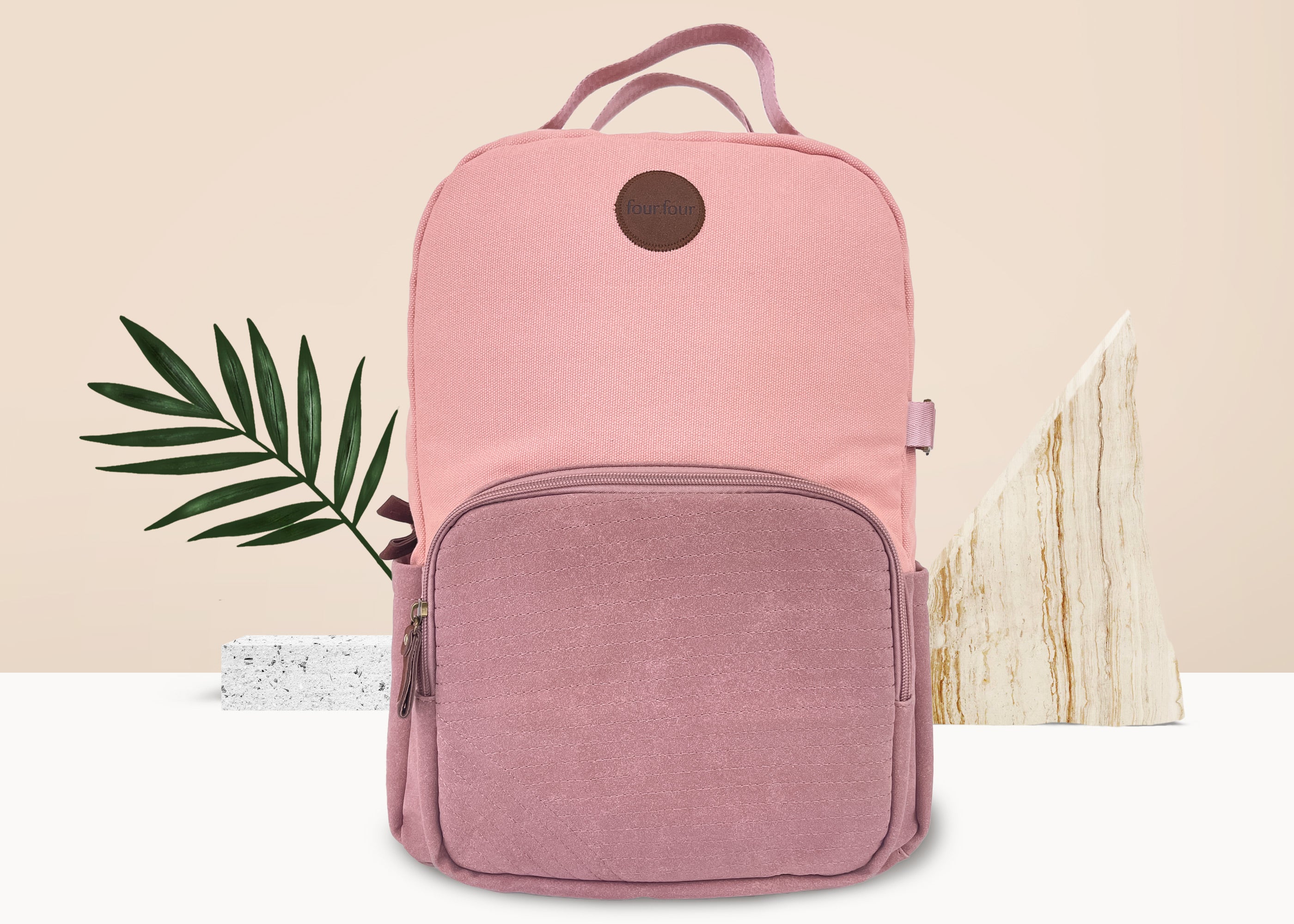 Stylish pink backpack with multiple pockets and a sleek design, featuring a secret back pocket and dedicated laptop compartment.