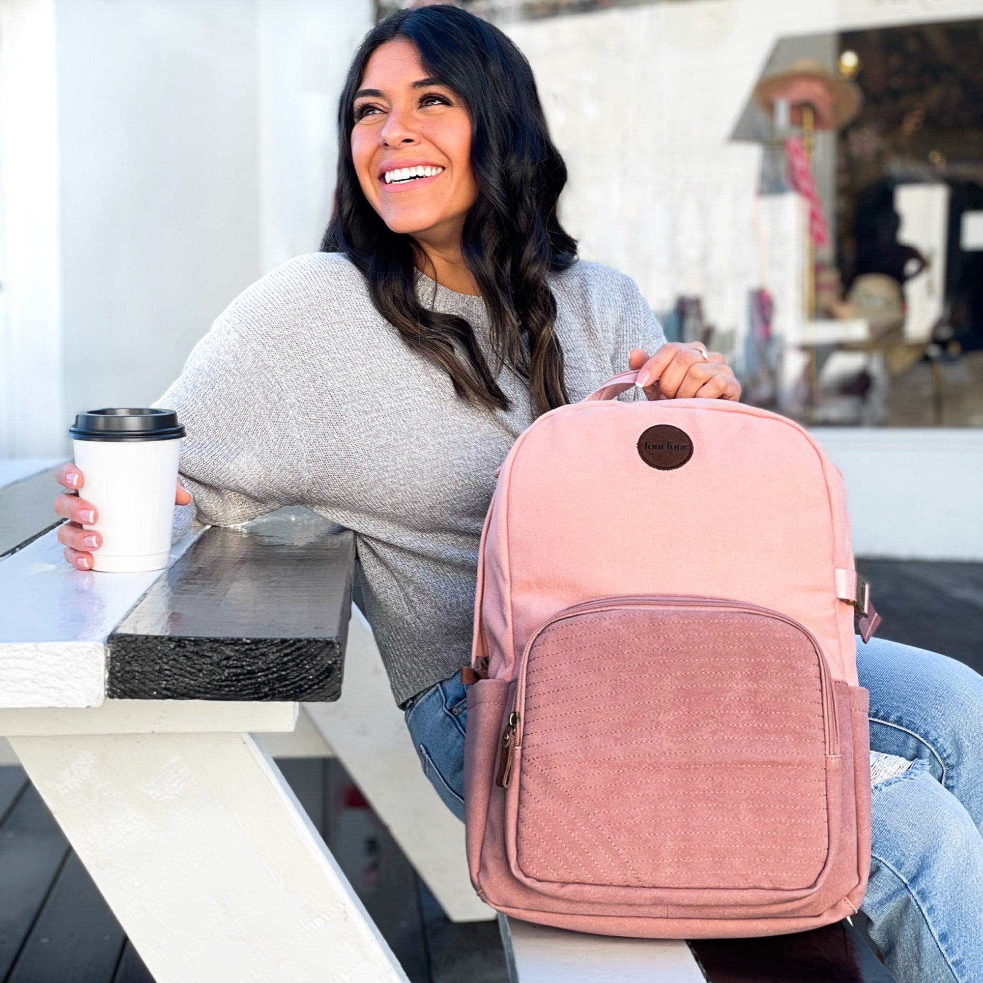 Stylish pink backpack with multiple pockets and a sleek design, featuring a secret back pocket and dedicated laptop compartment.