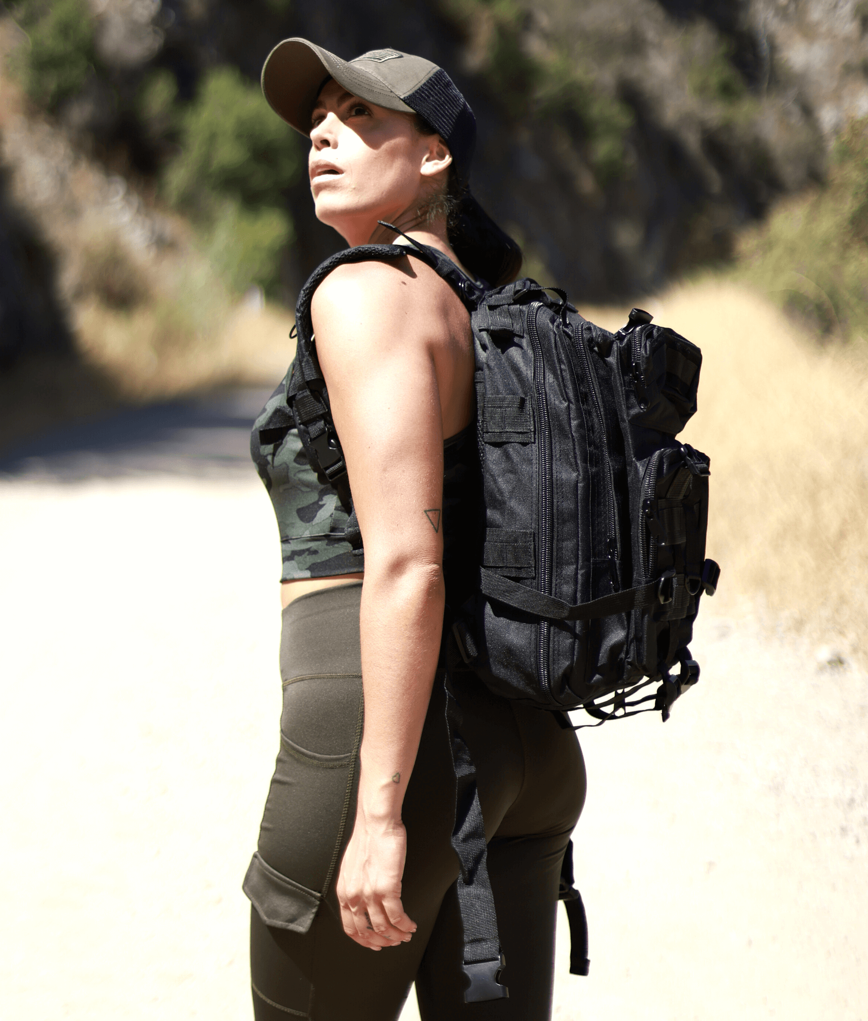 Tactical 25L Molle Backpack in olive green with multiple compartments and adjustable straps, ideal for outdoor activities and daily use.