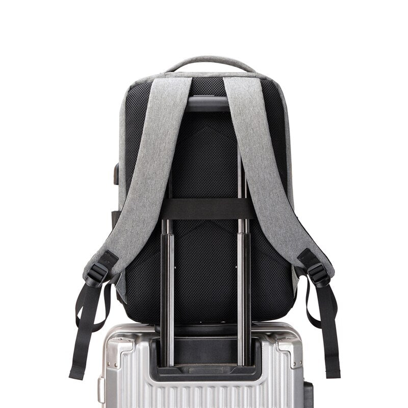 USB Charging Backpack for Men, waterproof and multifunctional with stylish patchwork design, featuring multiple pockets and USB charging port.