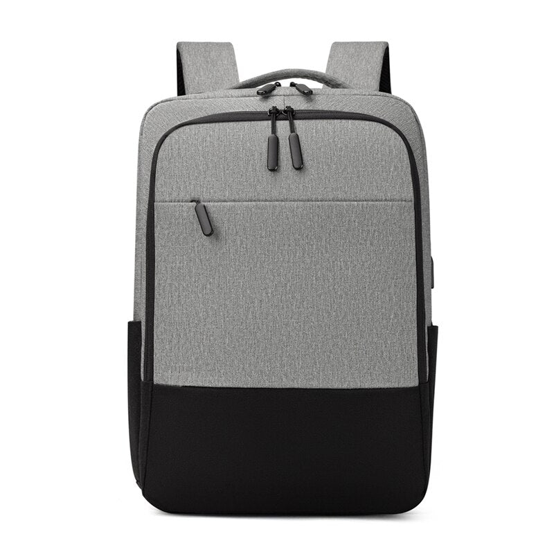 USB Charging Backpack for Men, waterproof and multifunctional with stylish patchwork design, featuring multiple pockets and USB charging port.