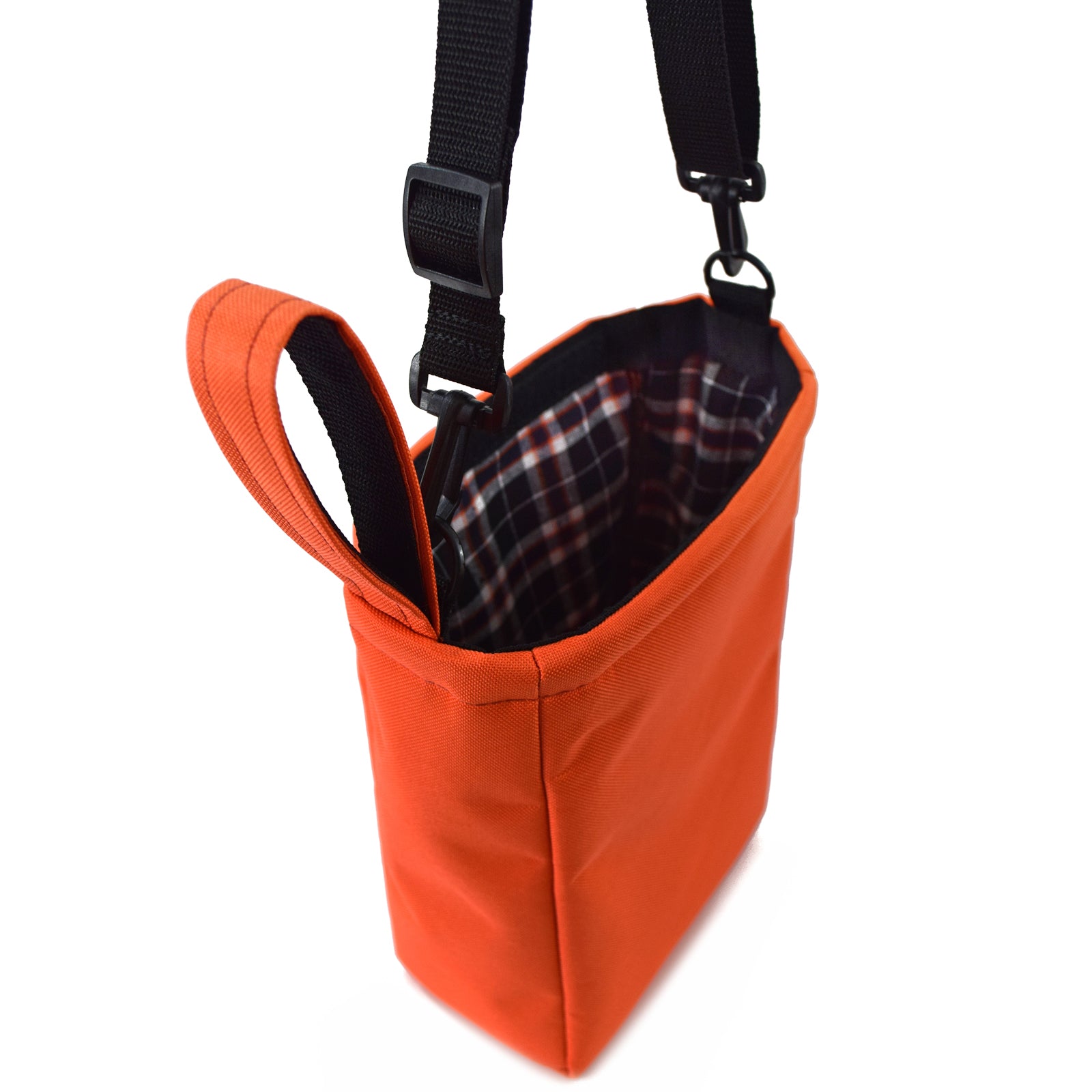 Bright orange UTILITY Pouch Grab Bag with cushioned interior and adjustable straps, ideal for organizing small items.