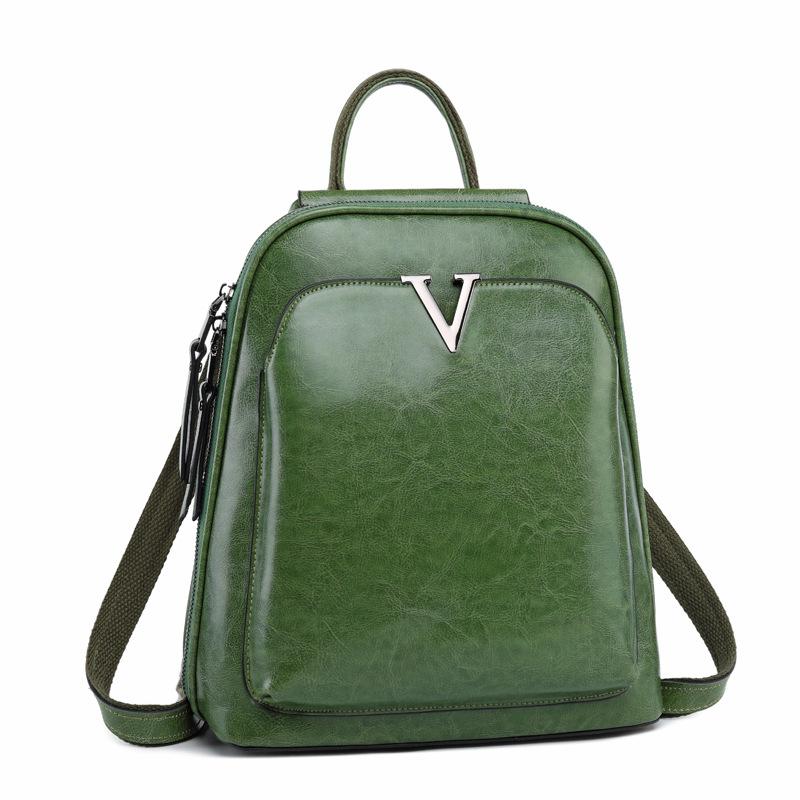 V Leather Backpack in Black made from top grain leather with adjustable shoulder strap and brass hardware, featuring multiple compartments.