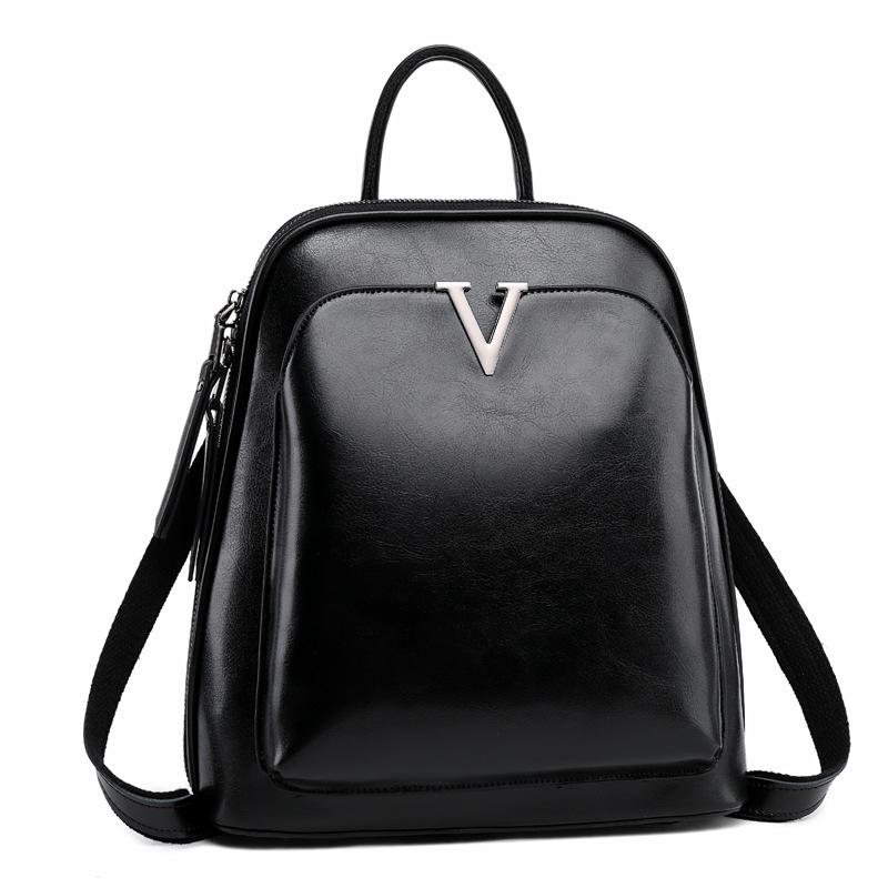 V Leather Backpack in Black made from top grain leather with adjustable shoulder strap and brass hardware, featuring multiple compartments.