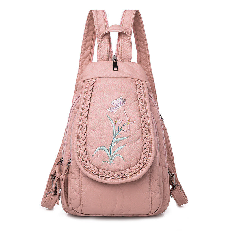 Women's Casual Backpack featuring elegant orchid embroidery in pink and white, designed for stylish everyday use.