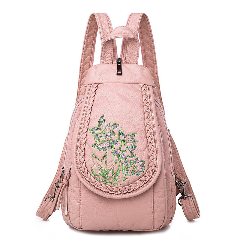 Women's Casual Backpack featuring elegant orchid embroidery in pink and white, designed for stylish everyday use.