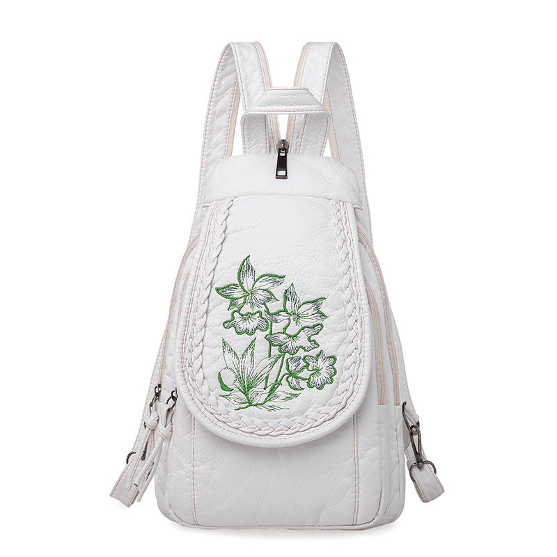 Women's Casual Backpack featuring elegant orchid embroidery in pink and white, designed for stylish everyday use.