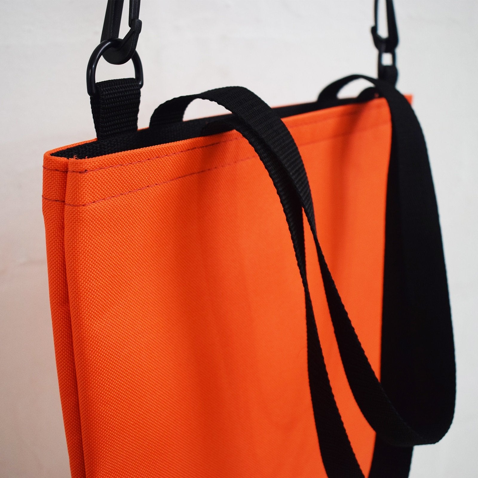 Orange WORK Tote Bag showcasing its compact and durable design, perfect for everyday use.