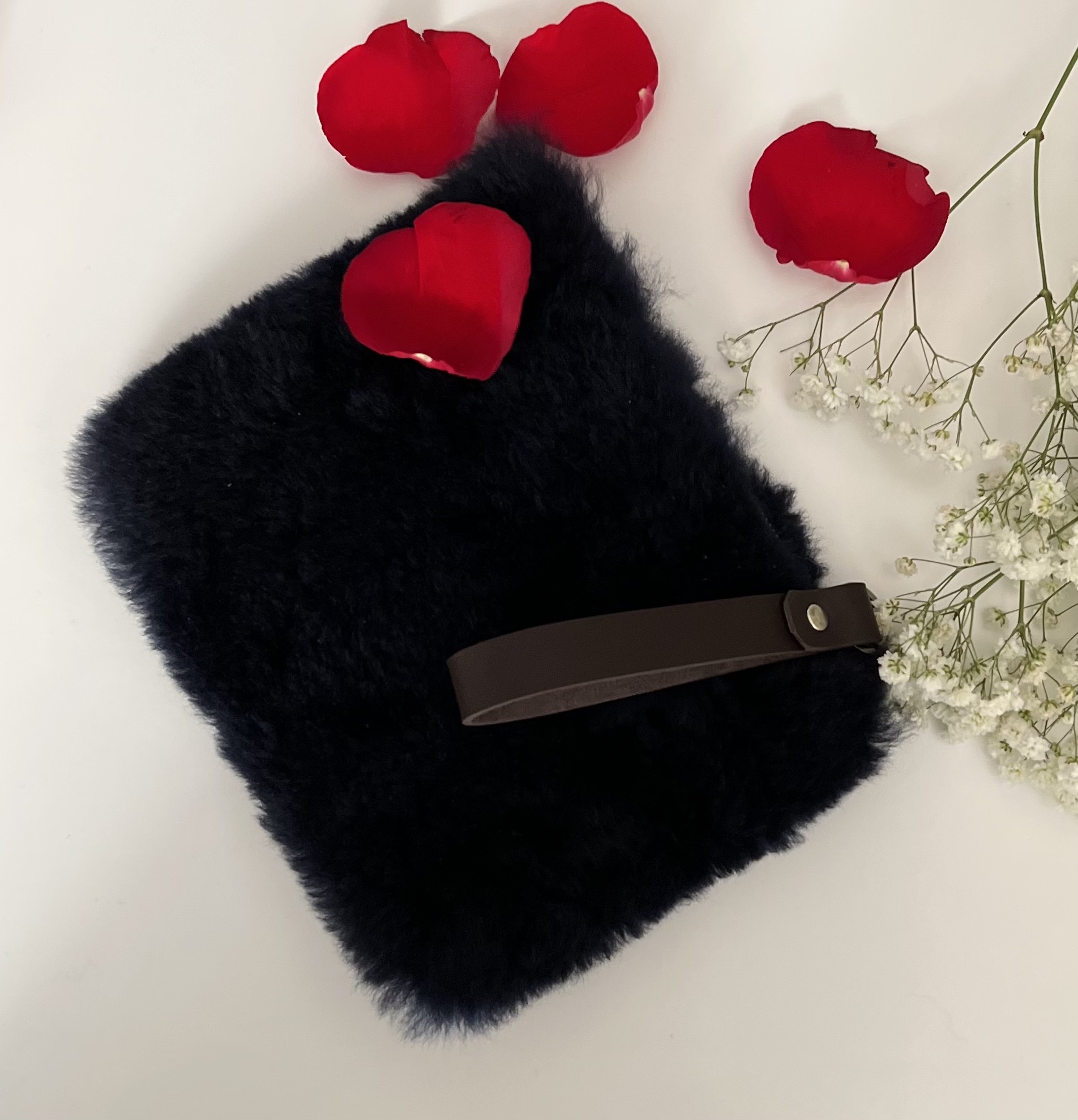 A luxurious Fur Wristlet made from soft baby alpaca fur, featuring a leather wristlet strap and zipper closure, available in Maroon, Navy, and Dark Grey.