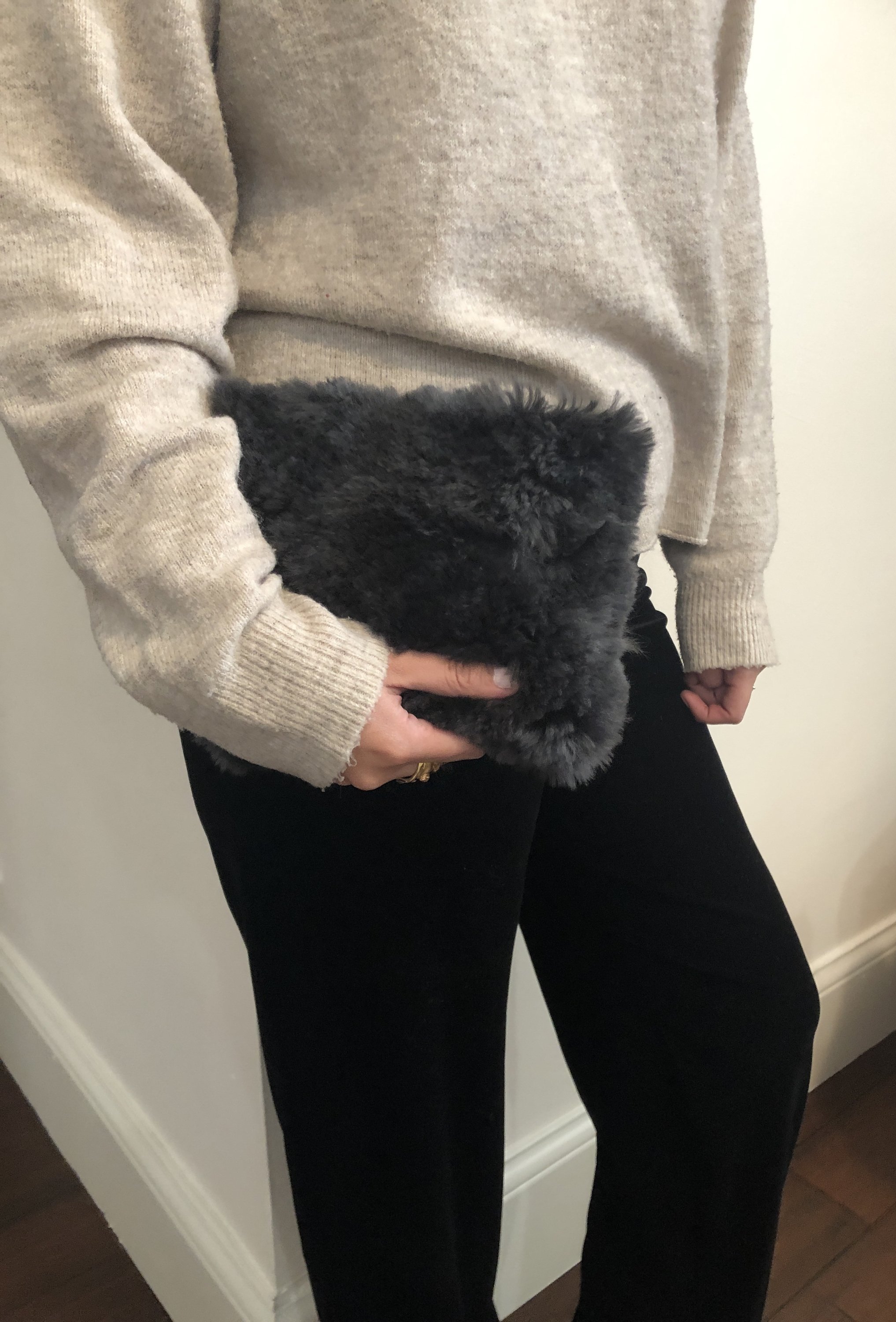 A luxurious Fur Wristlet made from soft baby alpaca fur, featuring a leather wristlet strap and zipper closure, available in Maroon, Navy, and Dark Grey.