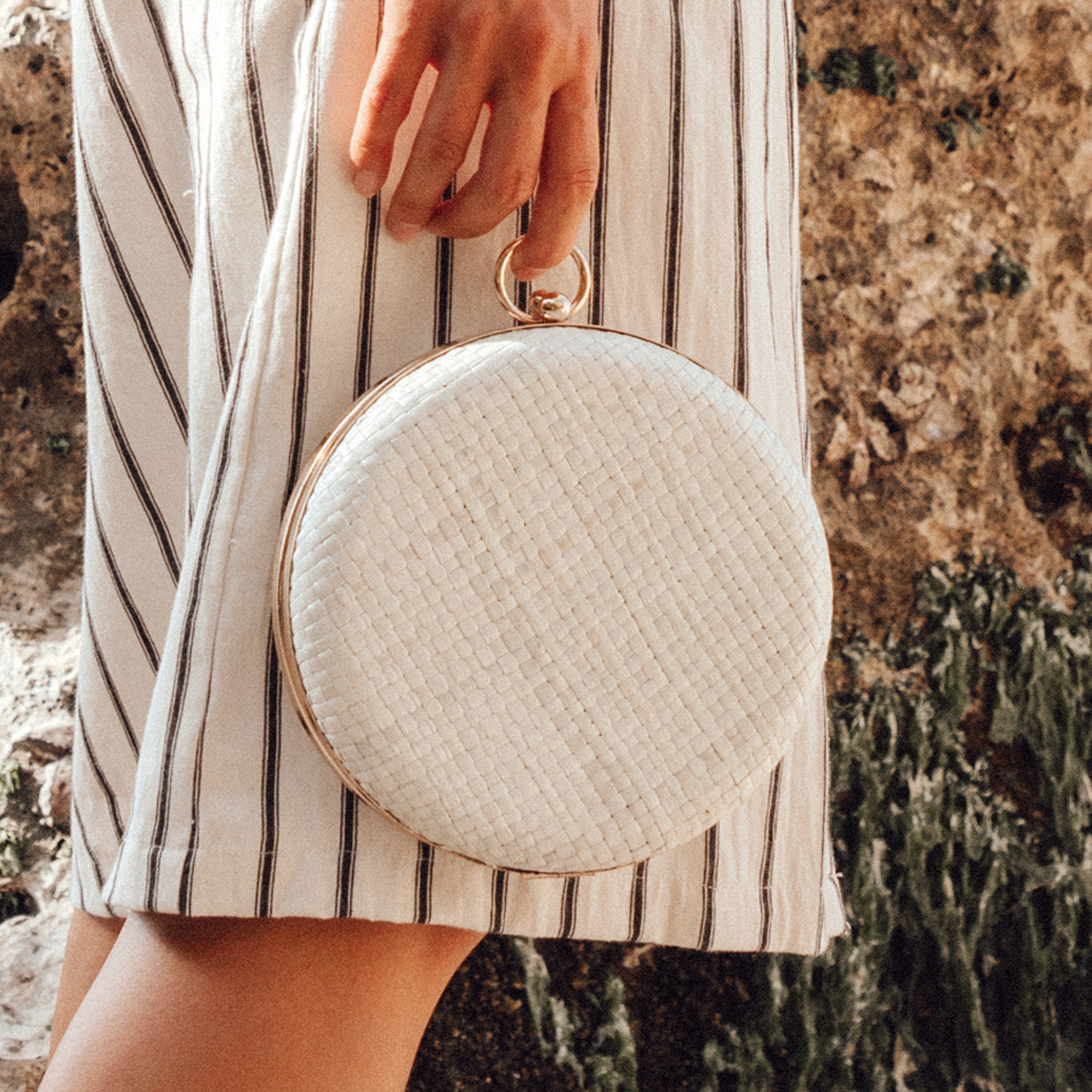 Matta Blanc Woven Hard Clutch featuring a shiny gold frame and natural pandan woven texture, elegantly designed for special occasions.