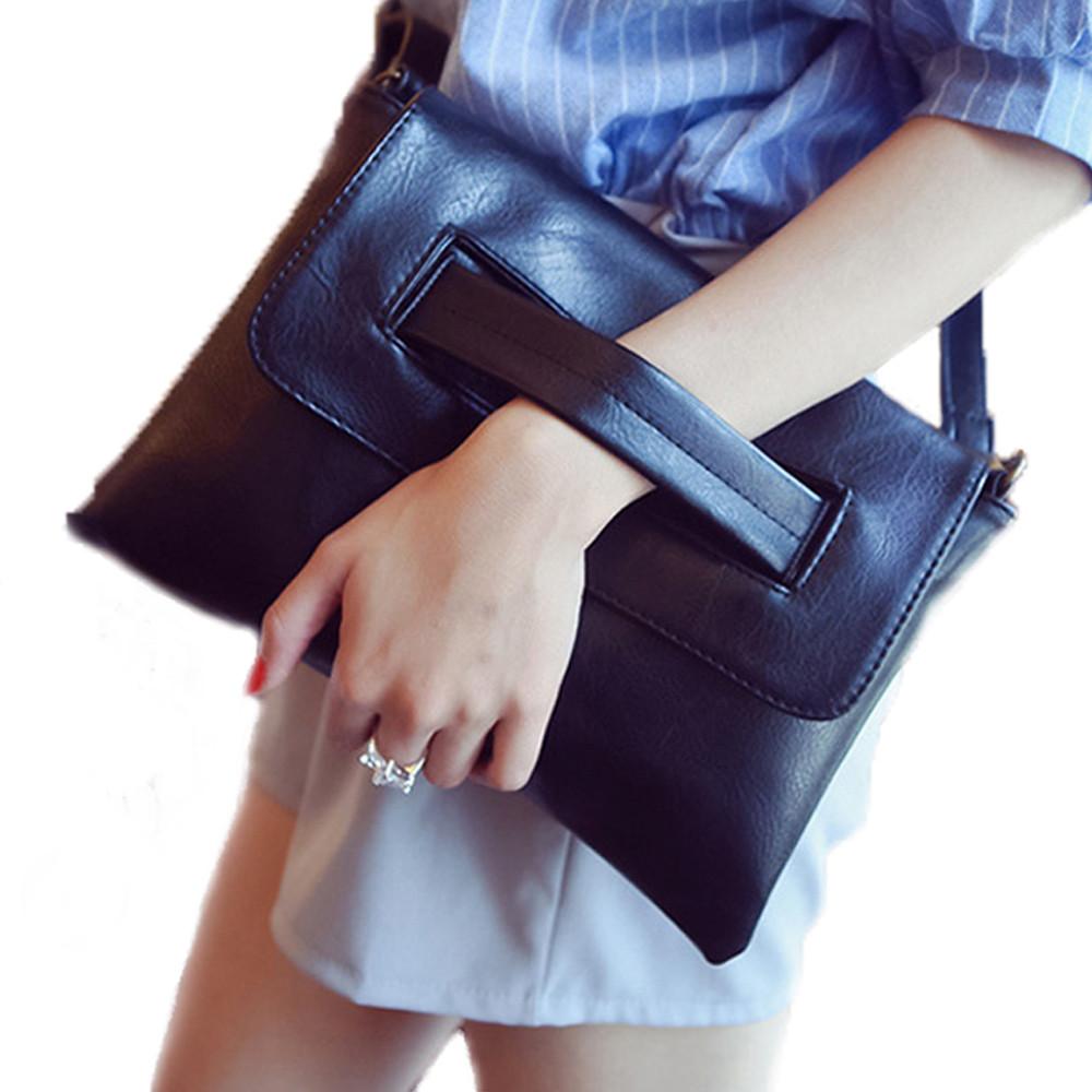 Womens Vegan Leather Envelope Clutch Bag in black, showcasing its sleek design and adjustable strap.