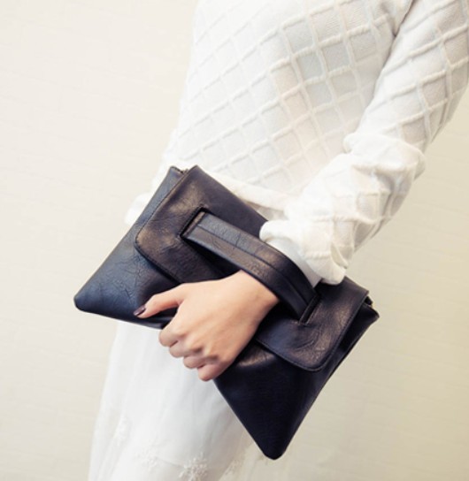 Womens Vegan Leather Envelope Clutch Bag in black, showcasing its sleek design and adjustable strap.