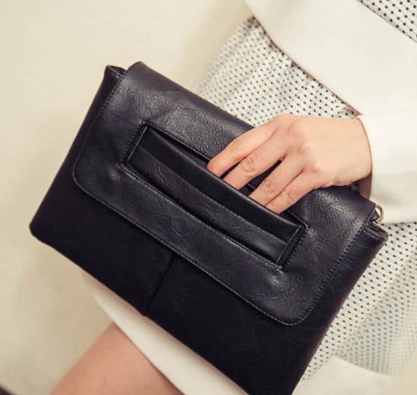 Womens Vegan Leather Envelope Clutch Bag in black, showcasing its sleek design and adjustable strap.