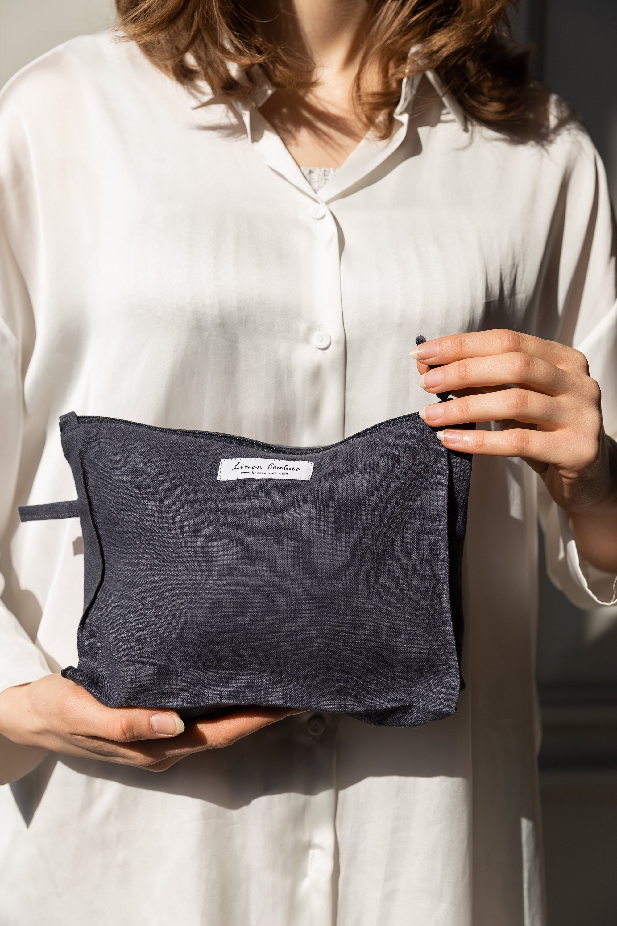 Asphalt grey linen large makeup bag with zipper, showcasing its elegant design and spacious interior for organizing beauty essentials.