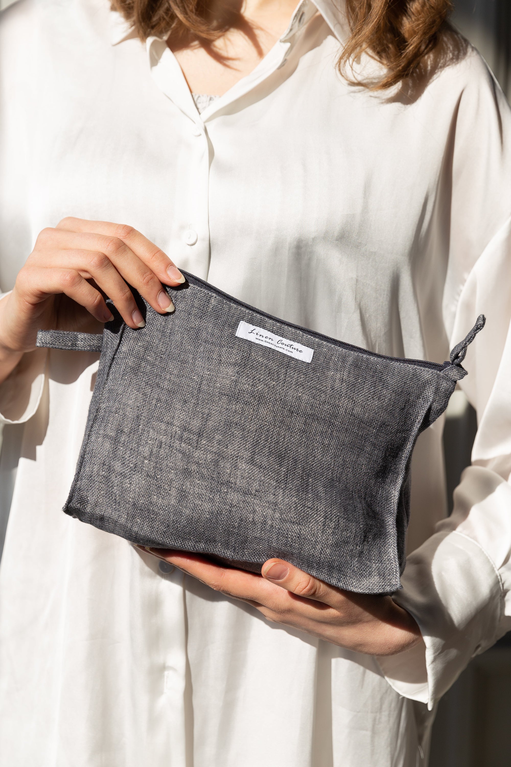 Asphalt grey linen large makeup bag with zipper, showcasing its elegant design and spacious interior for organizing beauty essentials.