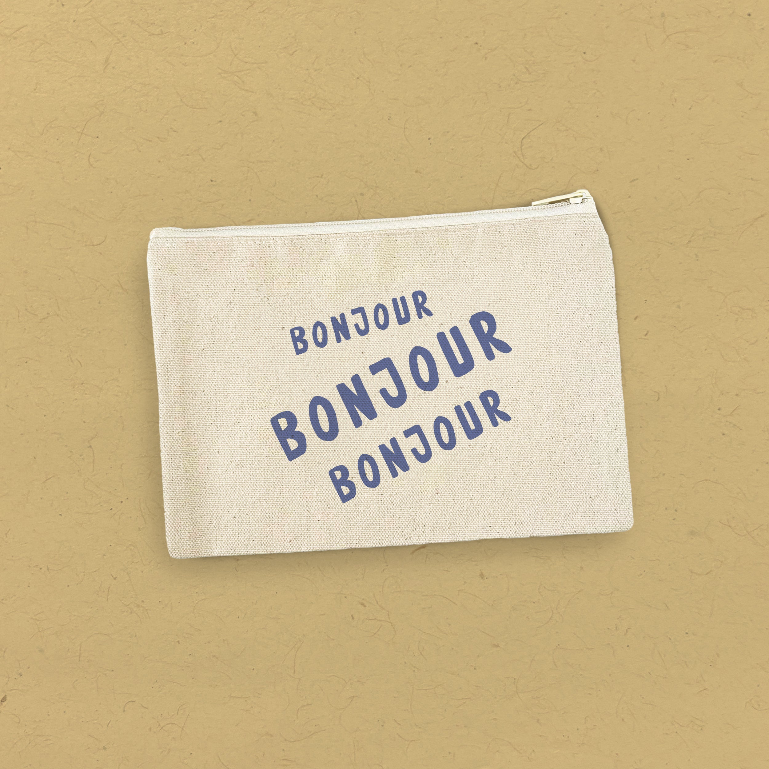 Bonjour Trois Canvas Zipper Pouch made from 100% cotton canvas with a natural color zipper, showcasing its stylish and durable design.