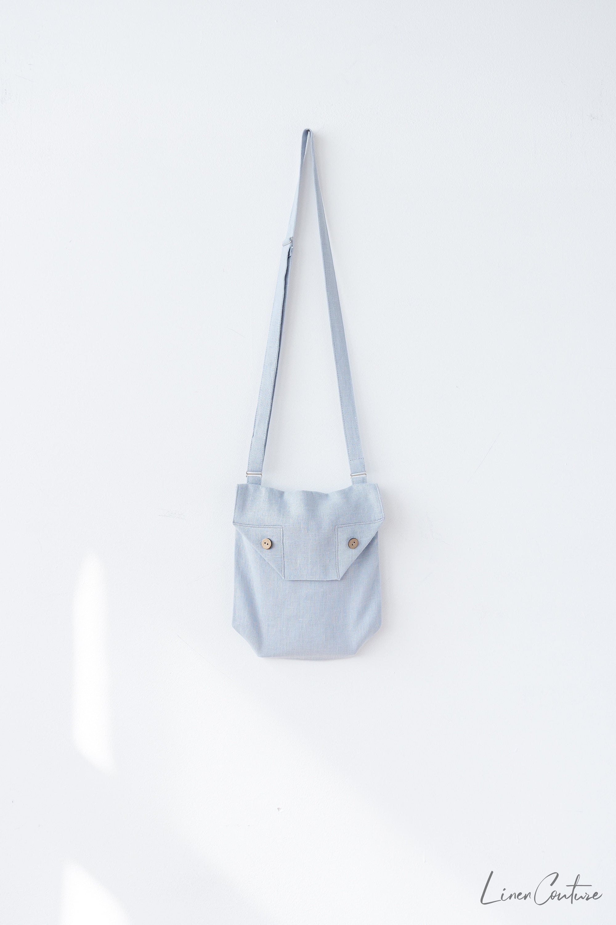 Honey Linen Shoulder Bag featuring coconut buttons and an adjustable strap, showcasing its elegant design and quality linen fabric.