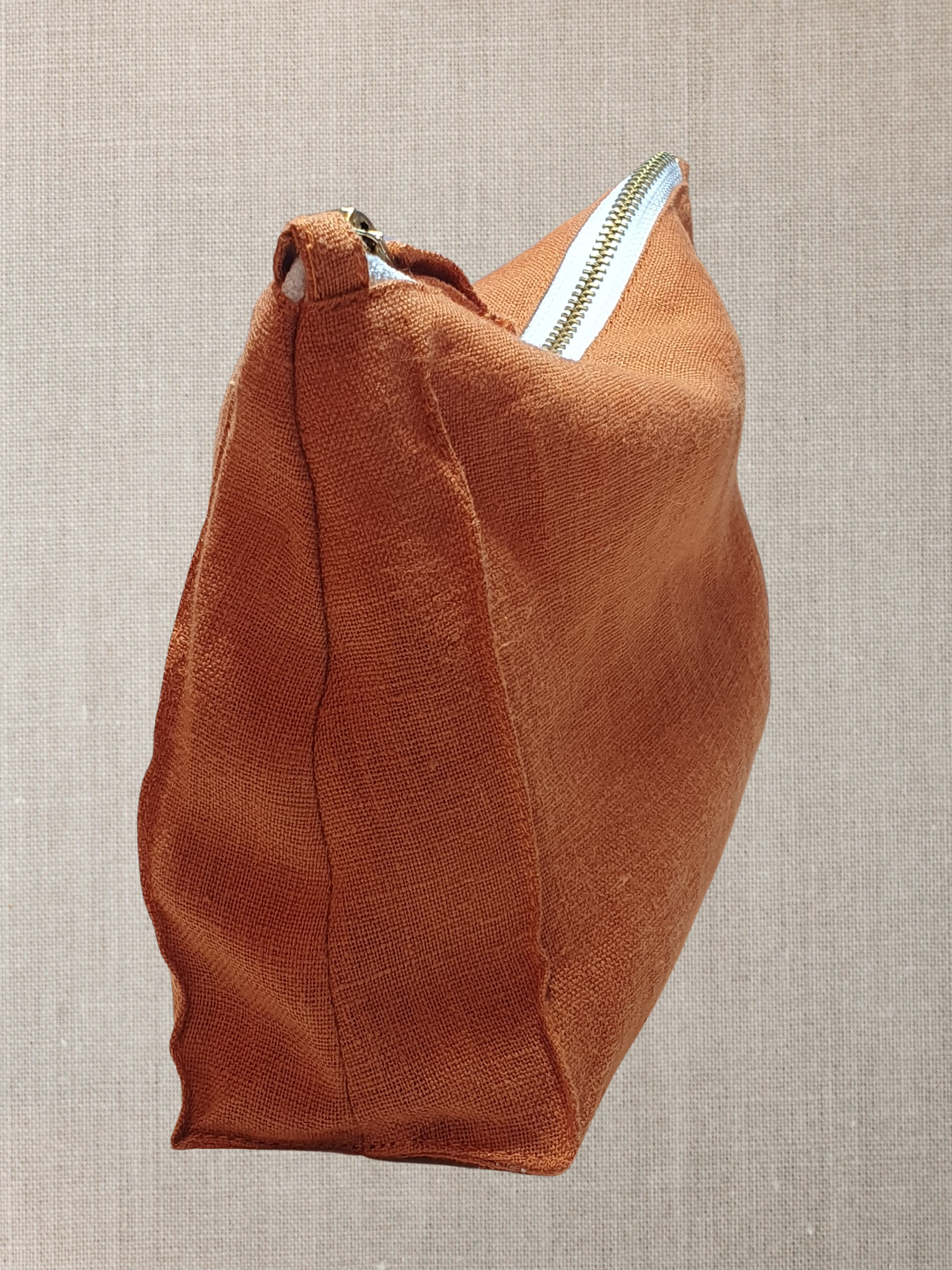 Light Chestnut linen toiletry bag with zipper, showcasing its soft texture and stylish design, perfect for travel and organization.