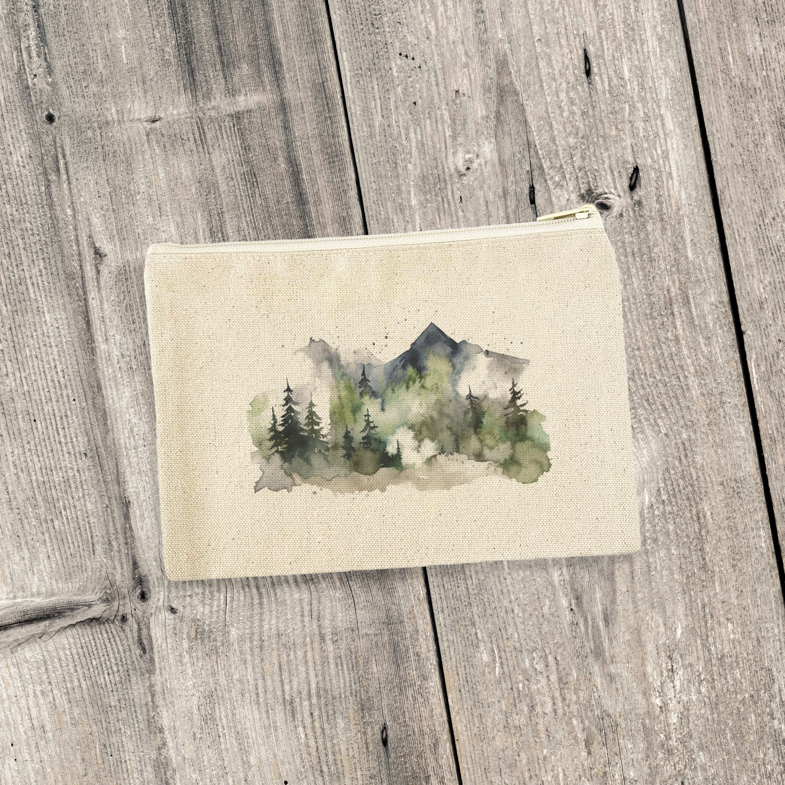 Misty Green Mountains canvas zipper pouch featuring a serene mountain design and natural color zipper, perfect for organization.