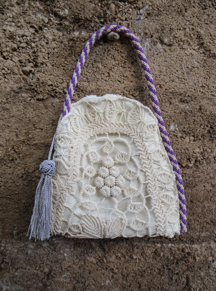 ANGLEZ n.2 handmade bag featuring traditional embroidery, linen lining, purple cord handle, and silver tassel.