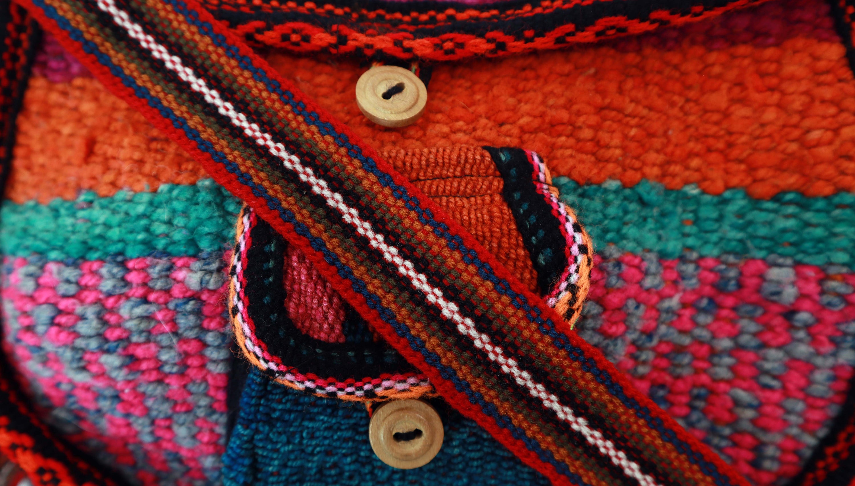 Artisan Woven Button Crossbody Bag featuring vibrant colors and intricate designs, handmade by Quechua artisans with natural dyes.