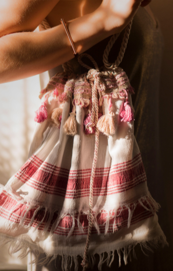 Beachy peshtemal featuring bronze sateen lining, double rose-gold cord, and decorative fringes, measuring 30H x 38W cm.