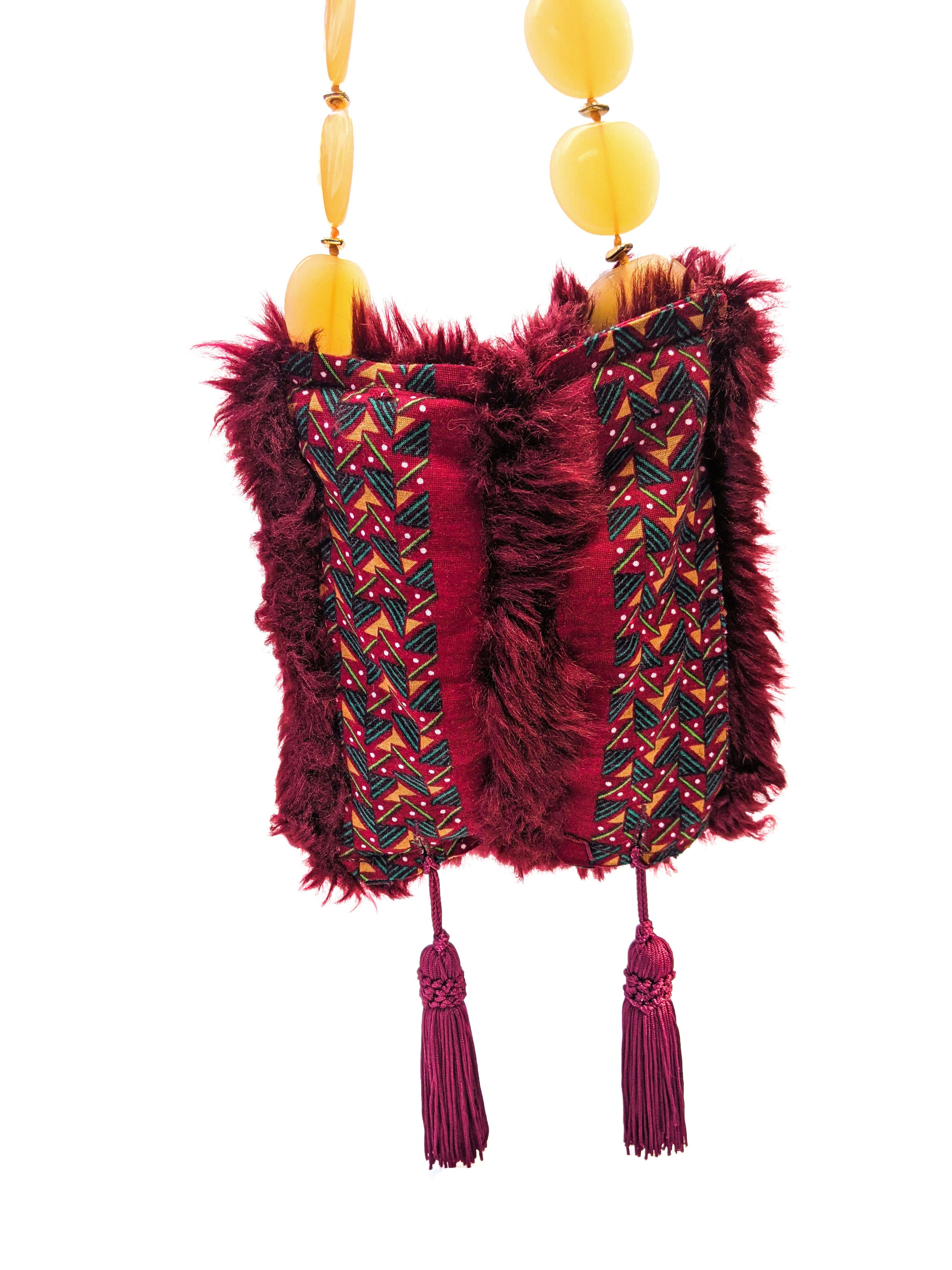 Stylish burgundy fur bag with tassels and yellow bead handle, showcasing unique Brecciated Jasper design.