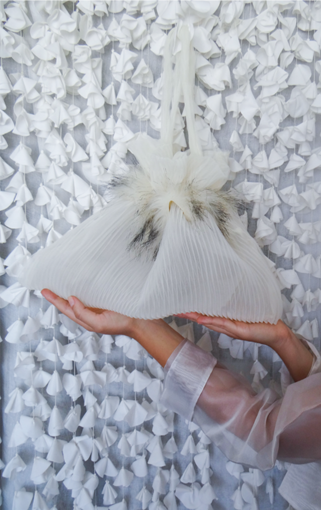 Stylish BRIDAL bag made from pleated chiffon with ecru-black fur decoration, showcasing modern upcycling.