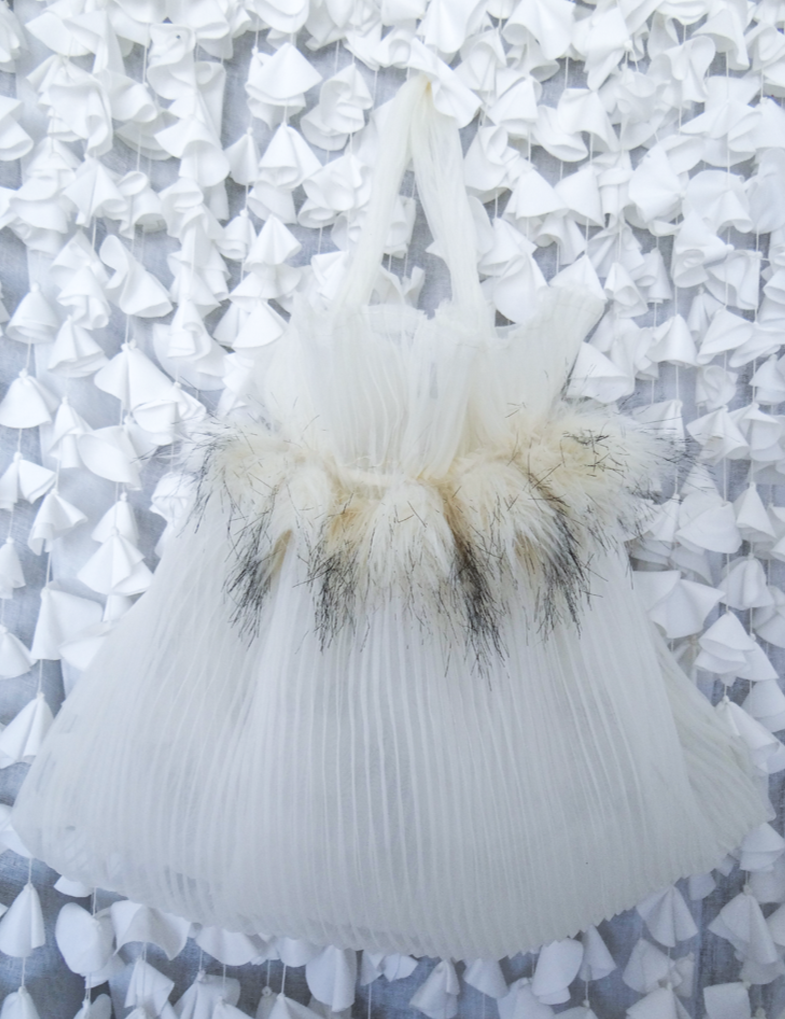 Stylish BRIDAL bag made from pleated chiffon with ecru-black fur decoration, showcasing modern upcycling.