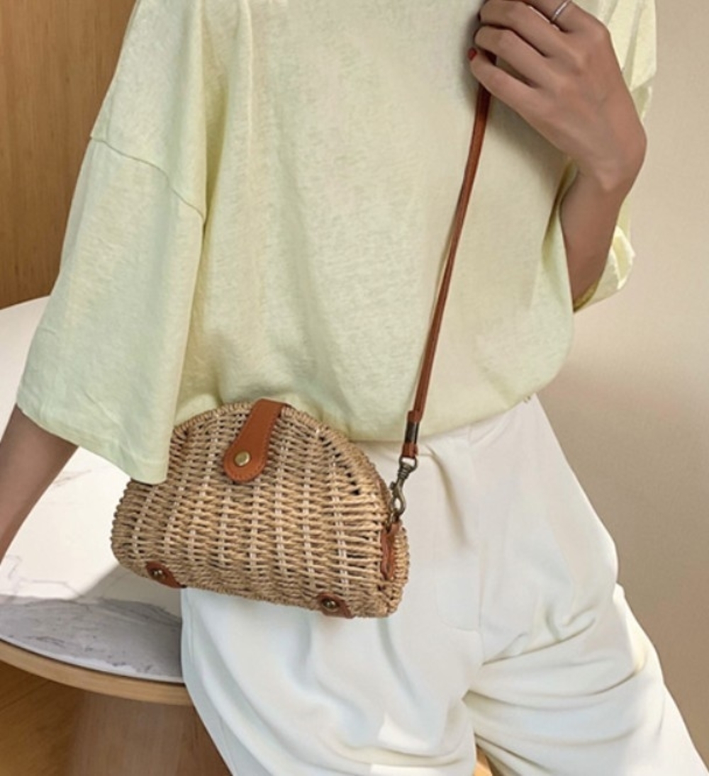 A stylish Casual Mini Oval Straw Crossbody Bag in khaki color, made from wicker straw, featuring an adjustable strap and chic oval design.