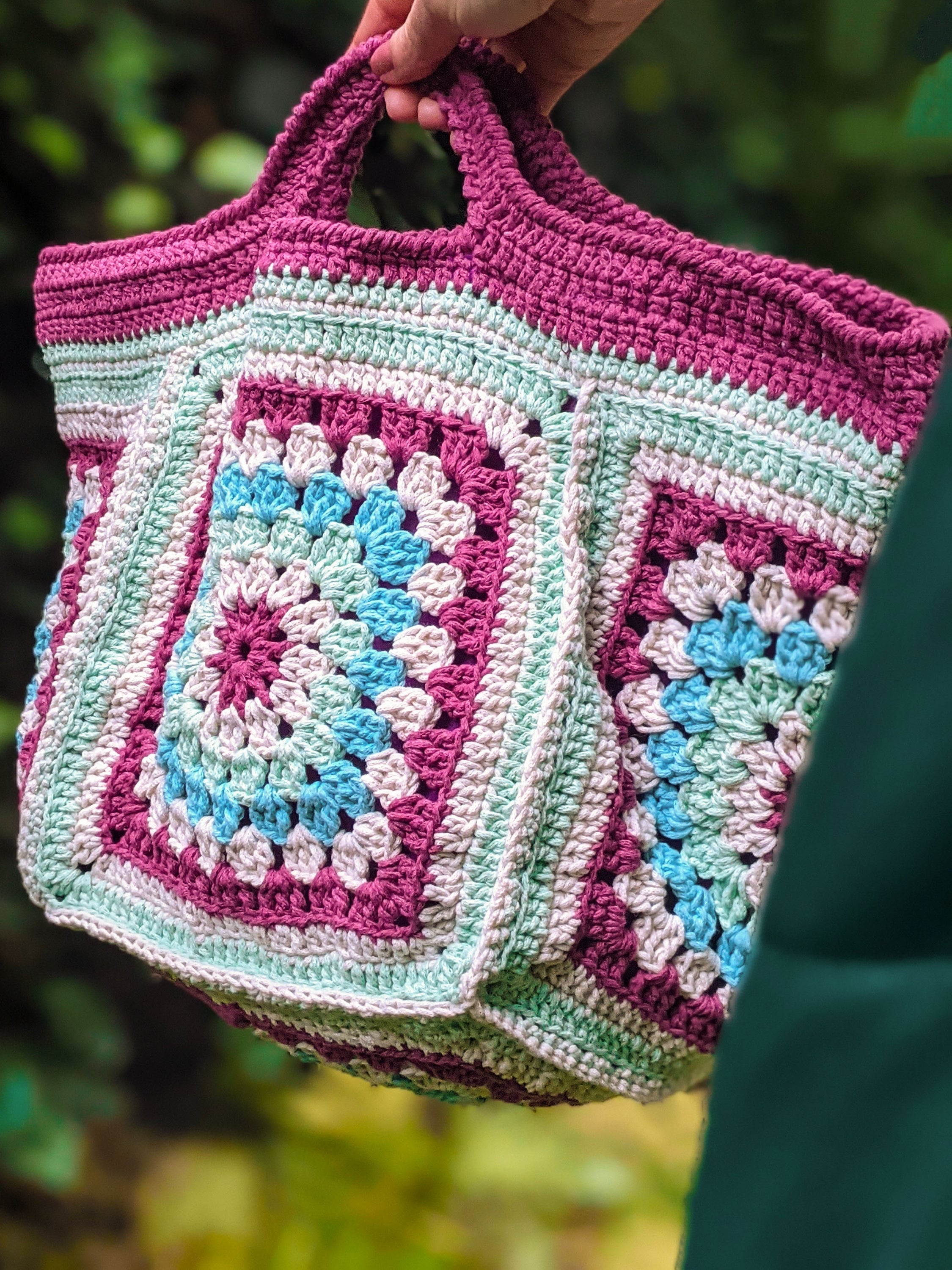 Handmade knit bag in burgundy, aqua, aquamarine, and off-white colors, measuring 45 cm x 17 cm.