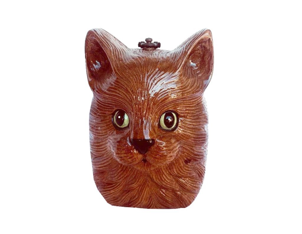 Charlie Cat handbag featuring a stylized green-eyed cat design, hand-carved wooden exterior, and satin lining.