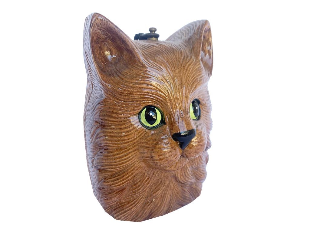 Charlie Cat handbag featuring a stylized green-eyed cat design, hand-carved wooden exterior, and satin lining.