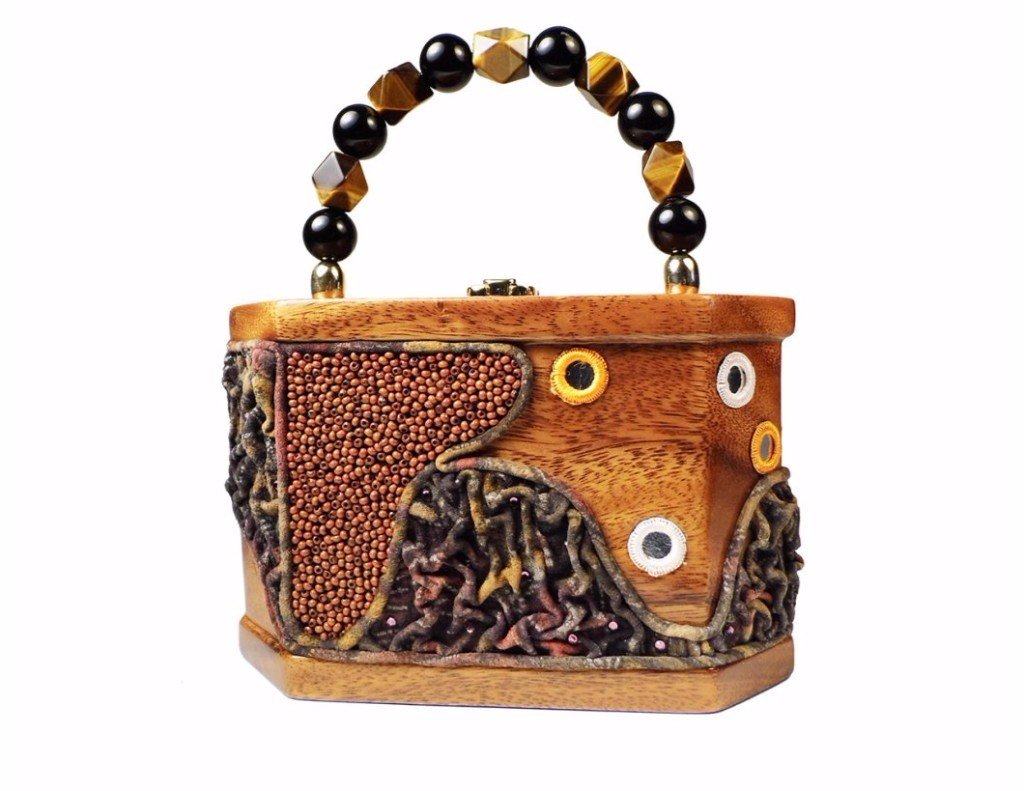 Charlotte handbag featuring modern angular design, carved Acacia wood, and semi-precious stone handle.