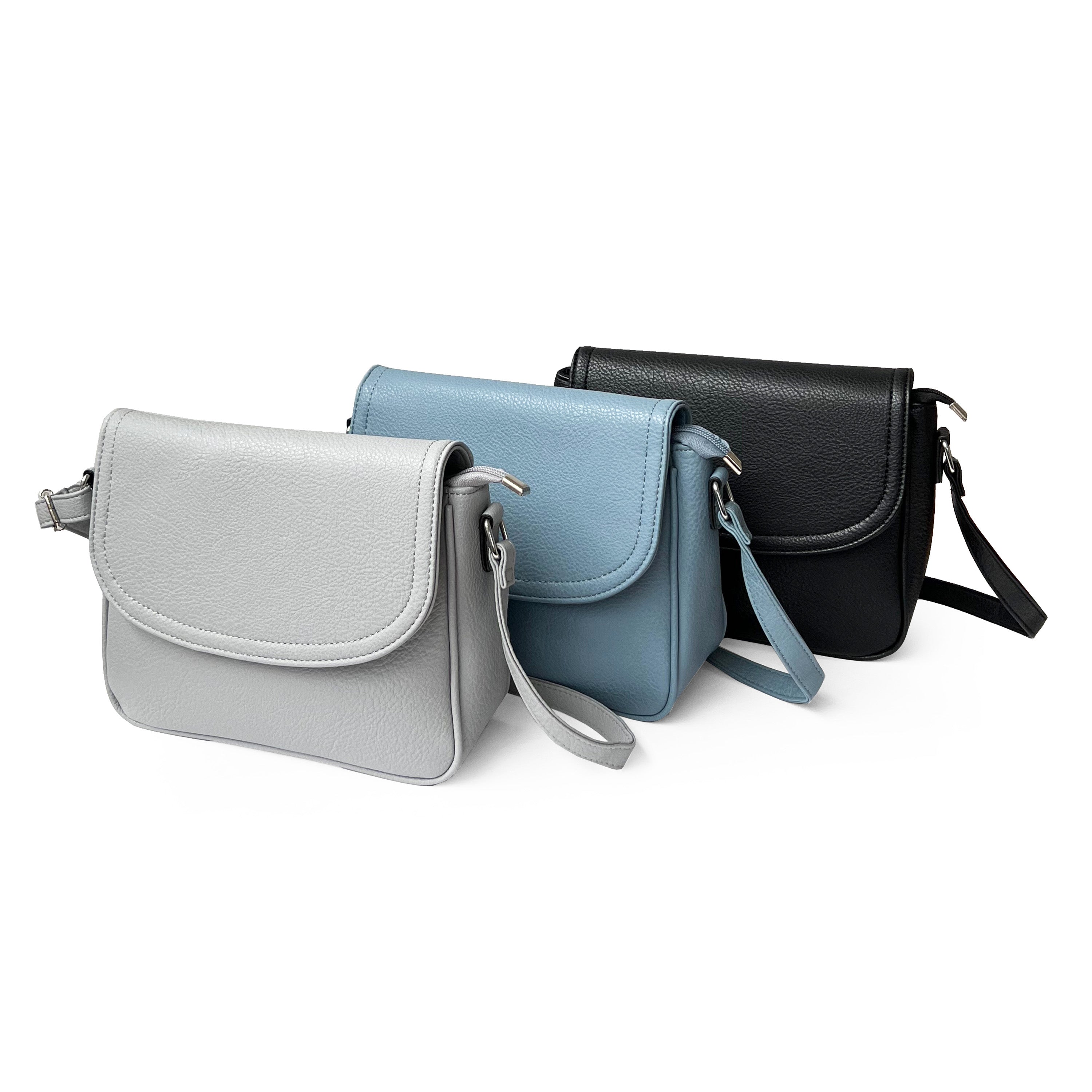 Stylish crossbody bag with rounded front flap, made from pebble PU, featuring adjustable strap and multiple pockets.