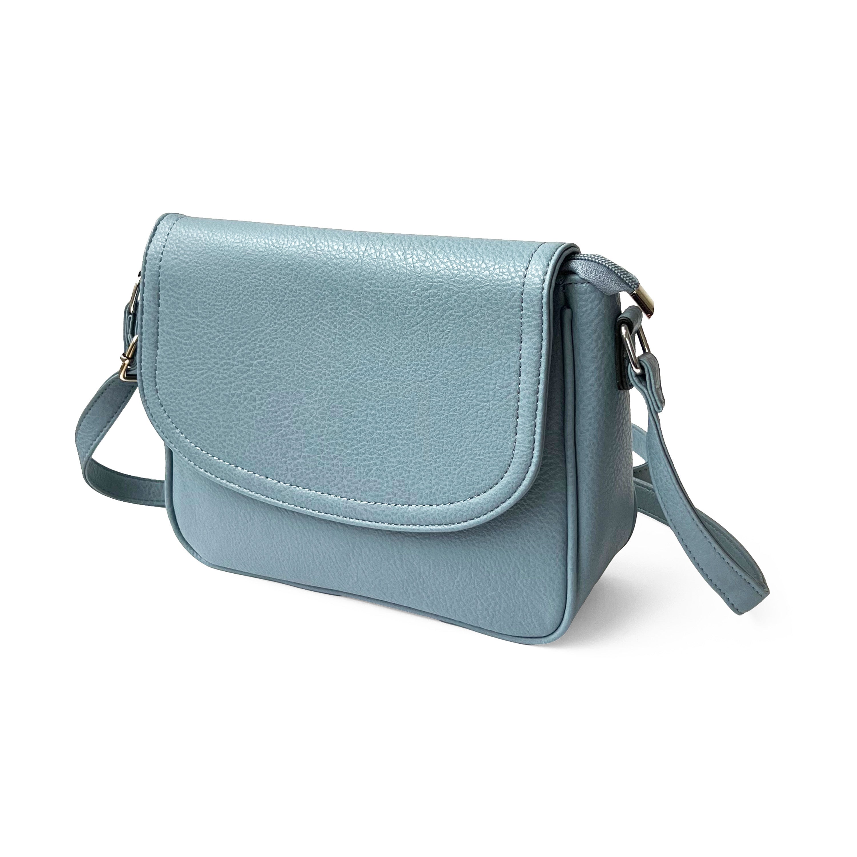 Stylish crossbody bag with rounded front flap, made from pebble PU, featuring adjustable strap and multiple pockets.