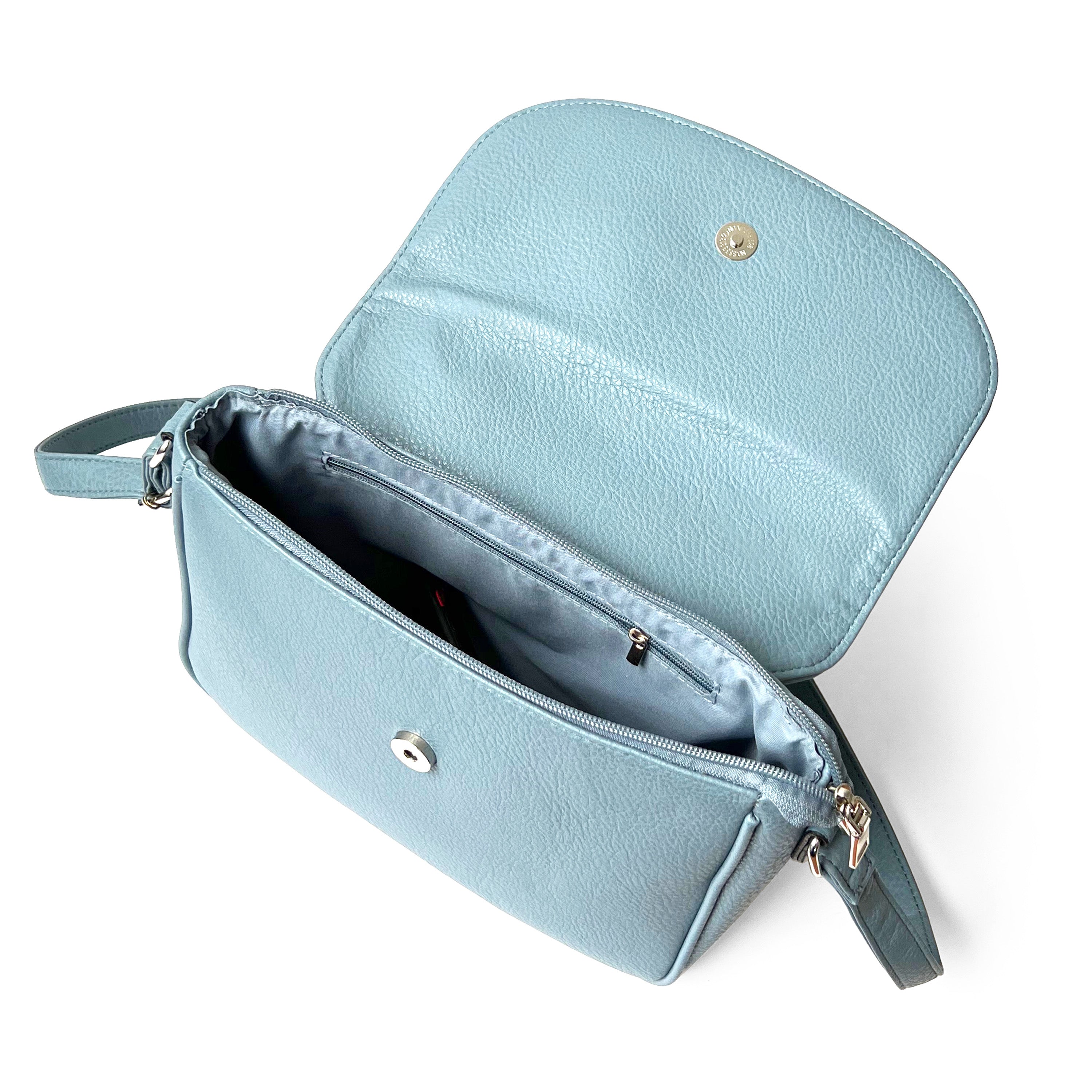 Stylish crossbody bag with rounded front flap, made from pebble PU, featuring adjustable strap and multiple pockets.