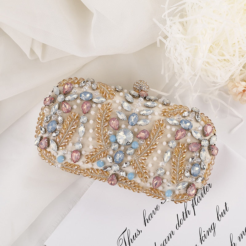 A luxurious champagne-colored crystal clutch bag adorned with rhinestones, perfect for weddings and formal events, featuring a floral pattern and a cell phone pocket.