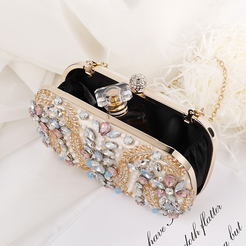 A luxurious champagne-colored crystal clutch bag adorned with rhinestones, perfect for weddings and formal events, featuring a floral pattern and a cell phone pocket.