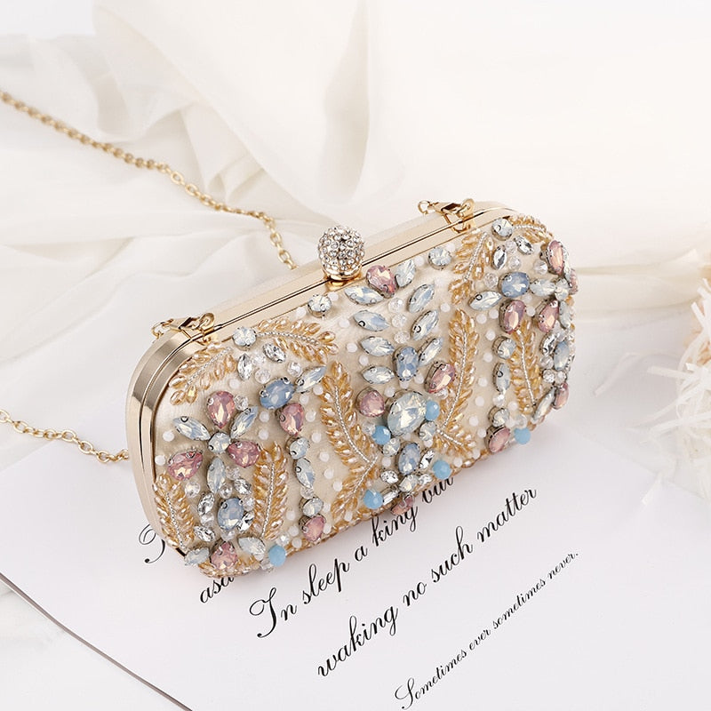 A luxurious champagne-colored crystal clutch bag adorned with rhinestones, perfect for weddings and formal events, featuring a floral pattern and a cell phone pocket.