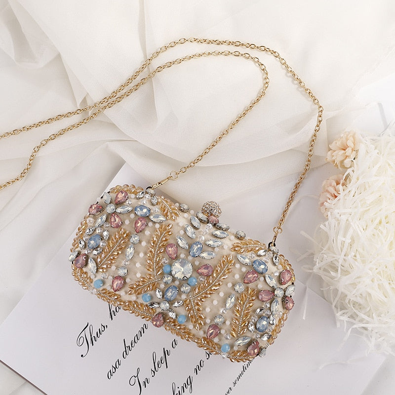 A luxurious champagne-colored crystal clutch bag adorned with rhinestones, perfect for weddings and formal events, featuring a floral pattern and a cell phone pocket.