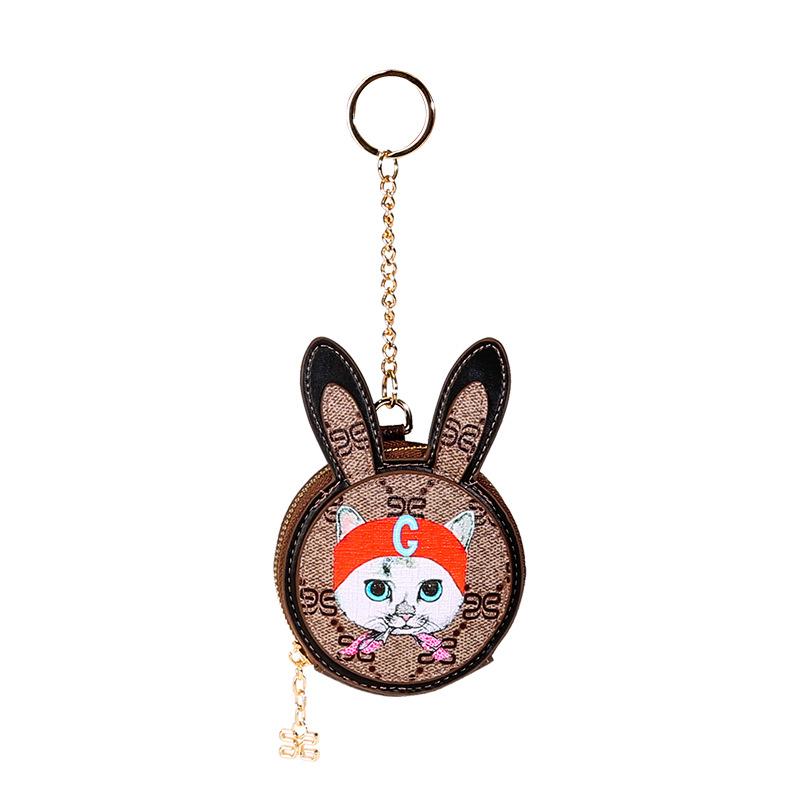 Cute mini cat purse coin bag for children made of genuine leather with gold fittings, perfect for storing coins and small items.